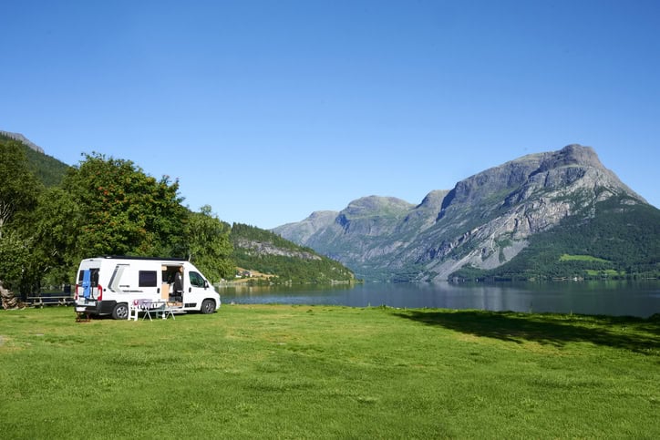 RV camping in nature with mountains in the background