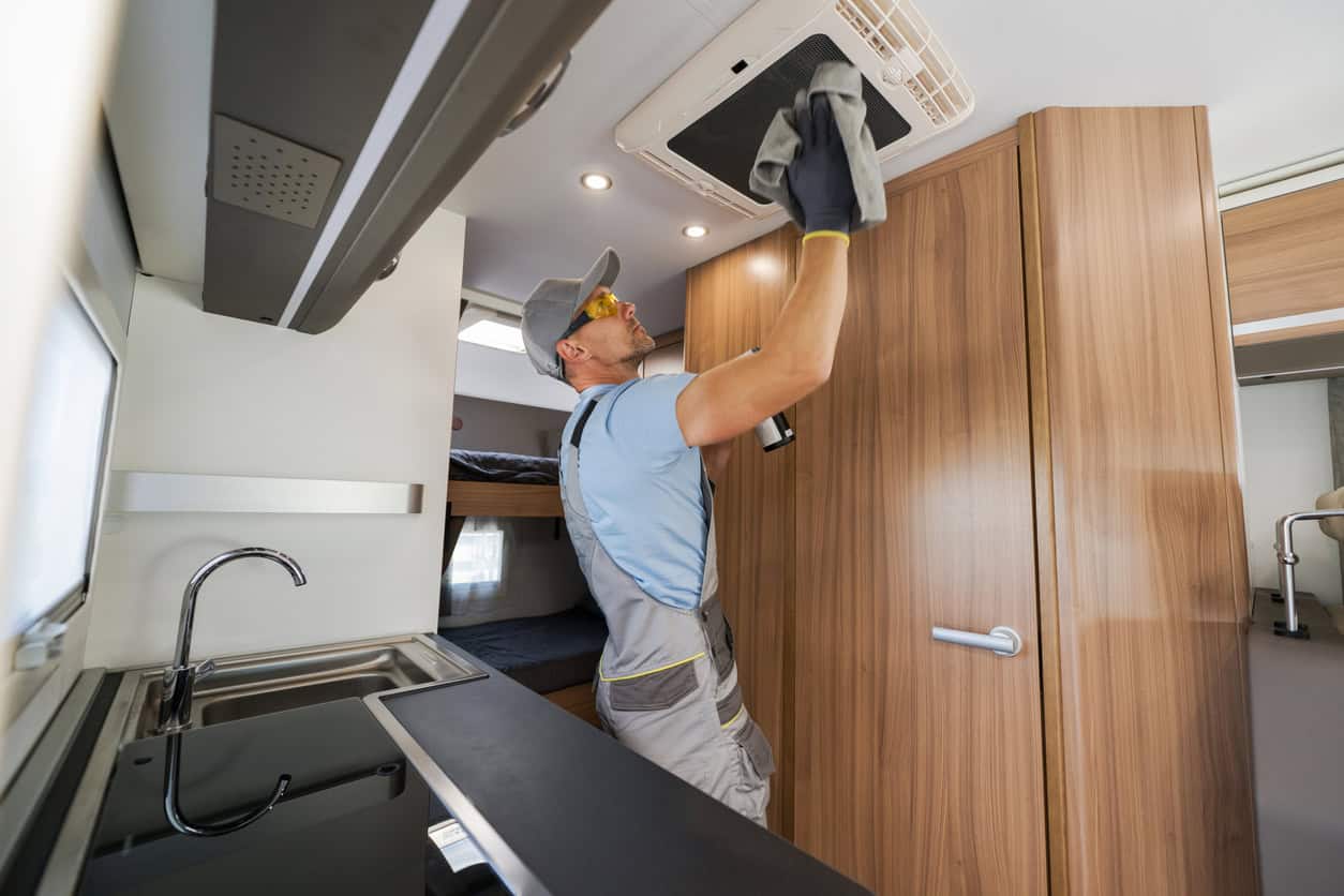 Man Fixing AC In An RV