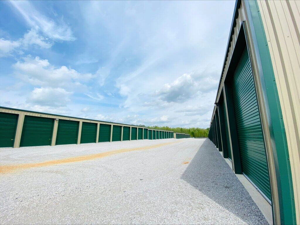 Outdoor shot of wide drive aisles and rows of enclosed parking -with closed green garage doors