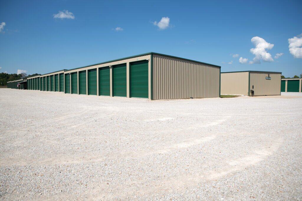 Outdoor shot of wide drive aisles and rows of enclosed parking -with closed green garage doors
