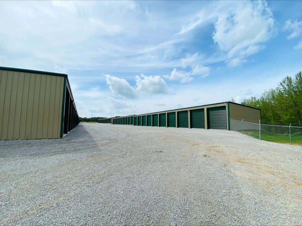 Outdoor shot of wide drive aisles and rows of enclosed parking -with closed green garage doors