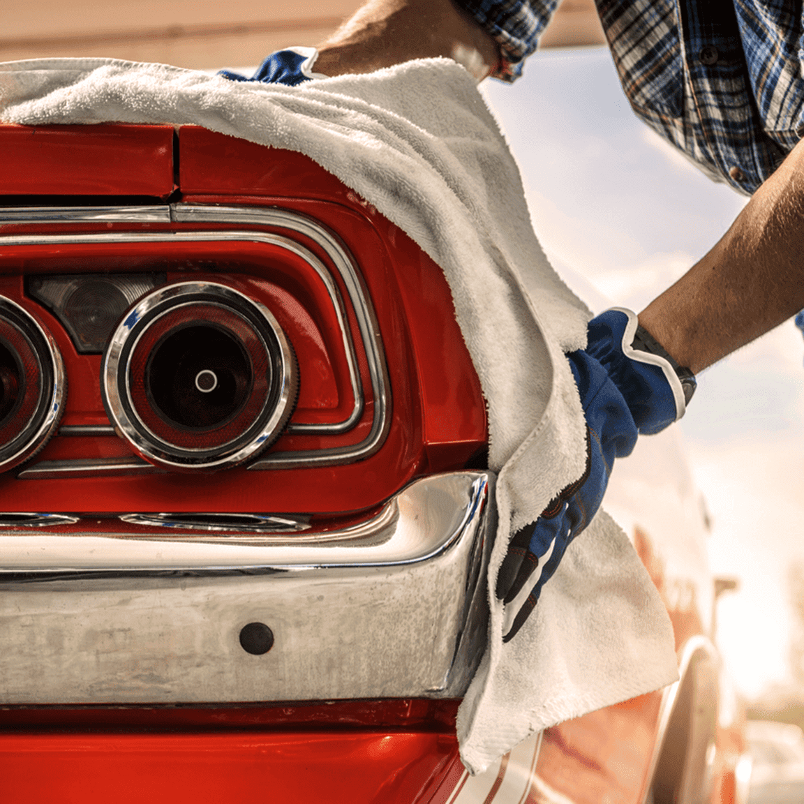 Classic car being cleaned with a soft cloth.