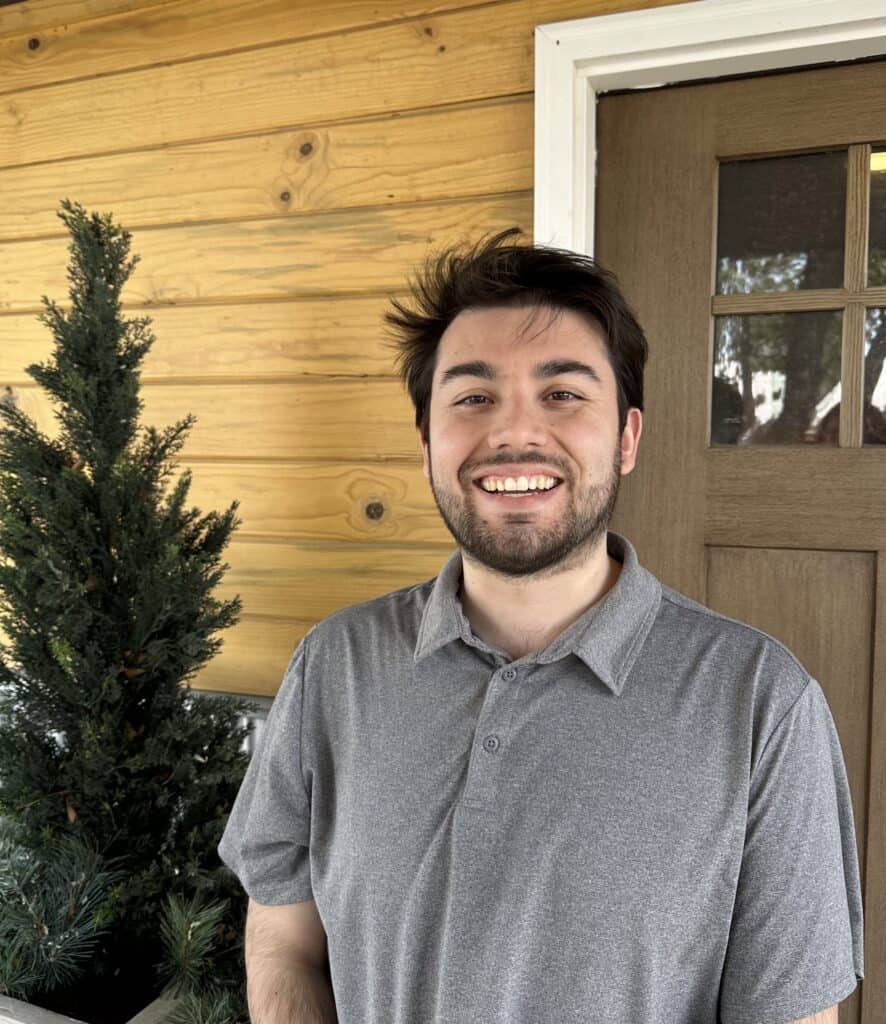 Man smiling in gray shirt