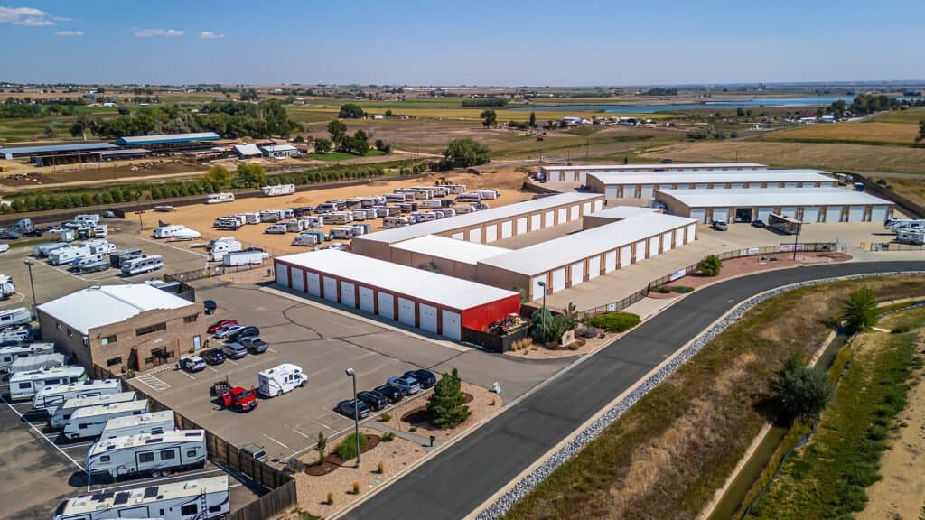Aerial Drone View of Outrig's Mead Garages Property featuring storage units and open parking