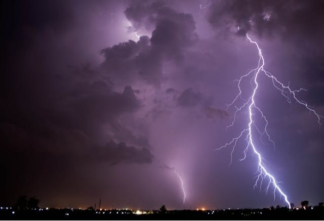 Horizon and dark night sky with a large bolt of lightning. RV Tornado.