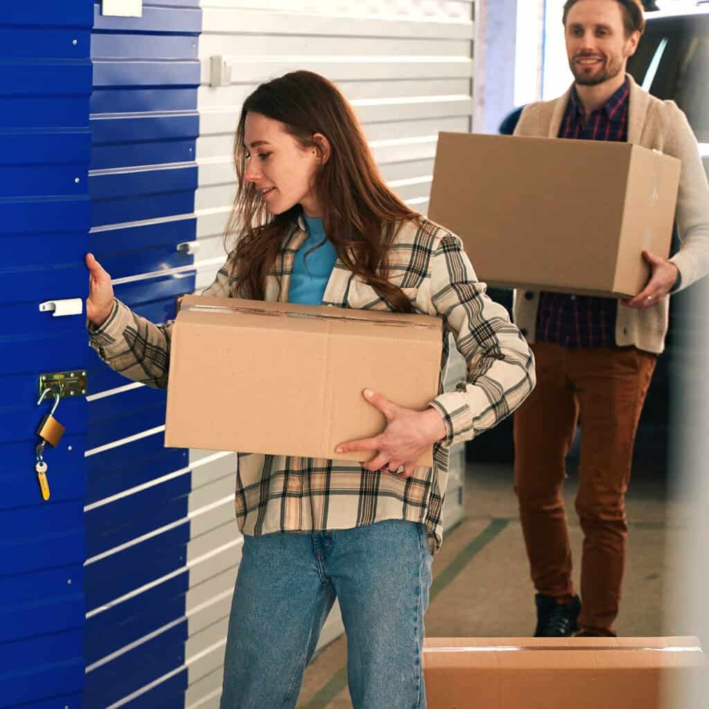 Self-Storage_Couple_iStock-1491007266 Couple moving boxes into a self-storage unit