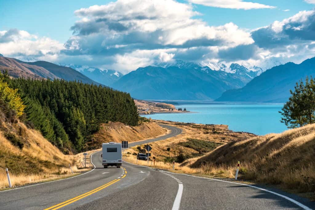 RV In The Open Roads With Mountains In The Background