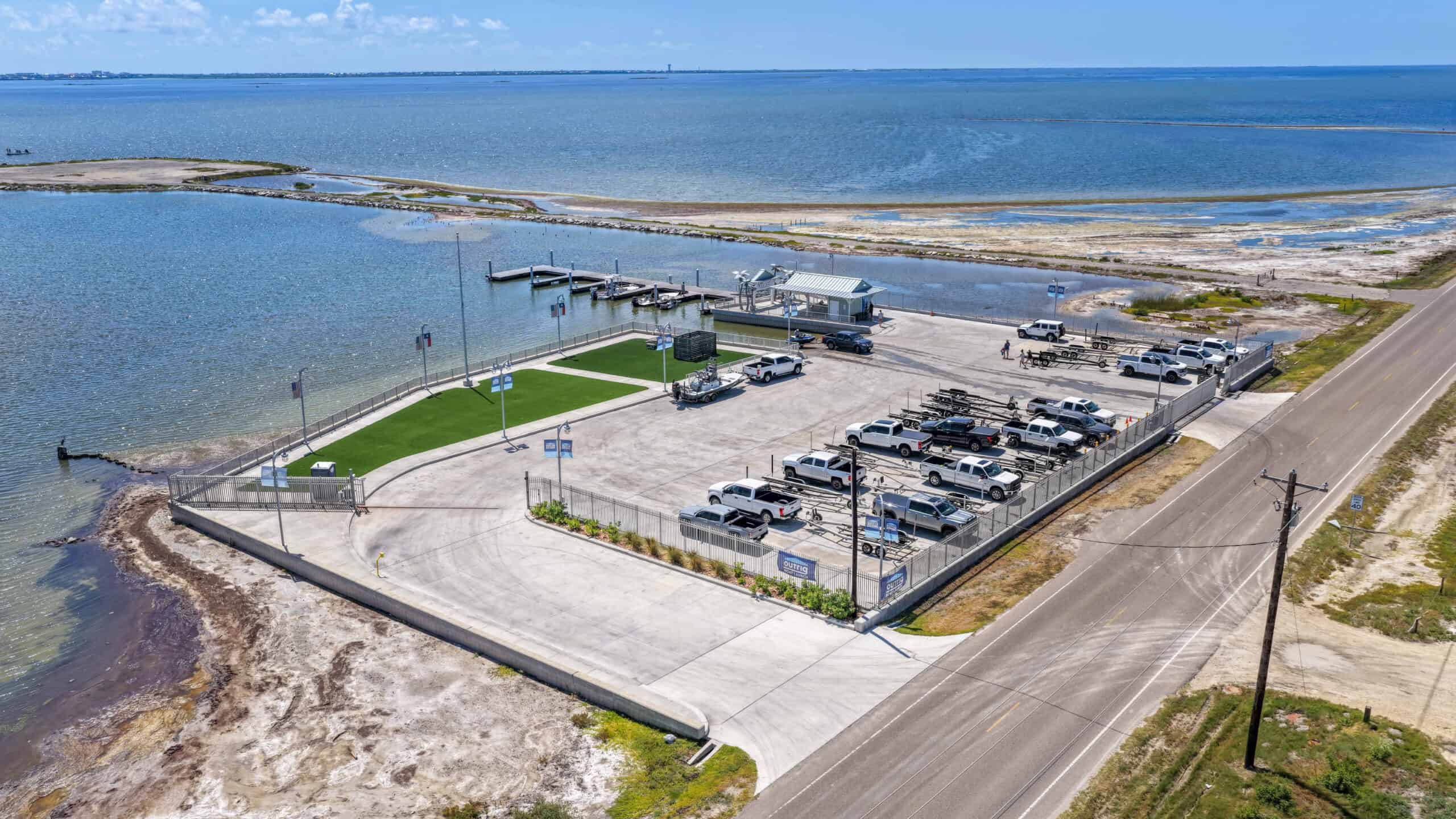 Modern waterfront parking lot with boat docks and scenic coastal views.