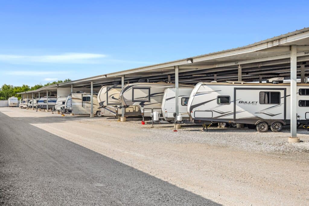 Outrig West 08252025-2-min RV storage facility with multiple recreational vehicles parked under a covered shelter for protection and easy access.