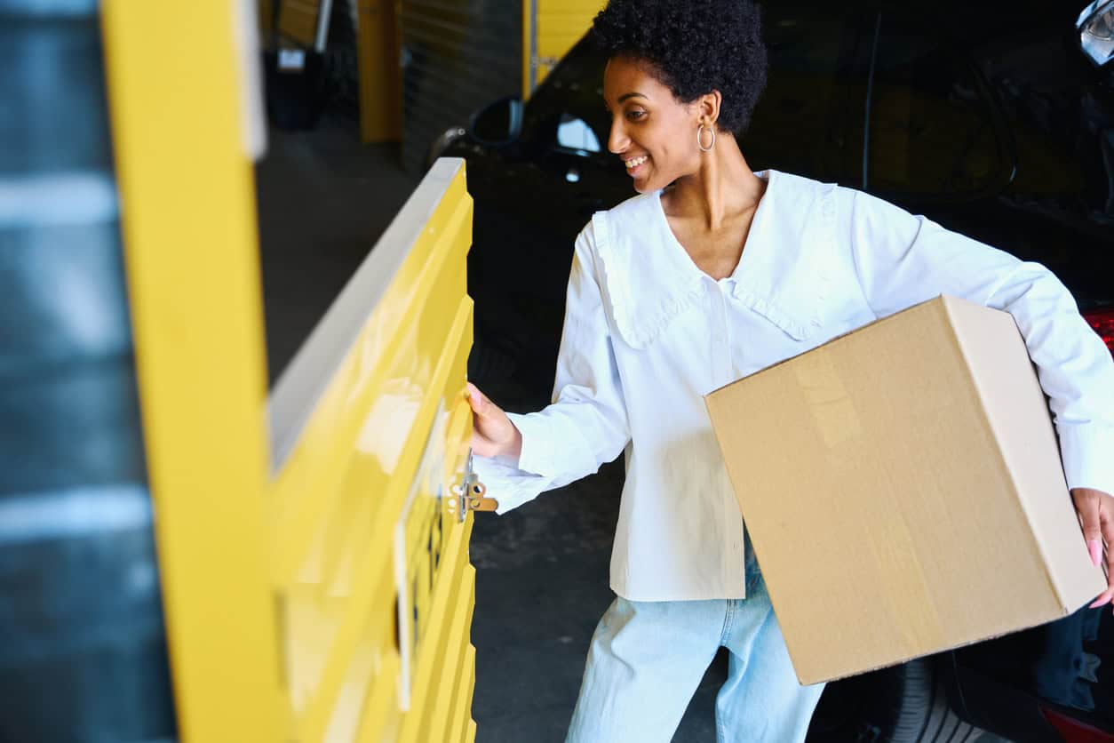 Package delivery person dropping off a box at a parcel locker, outdoor delivery service, fast shipping.