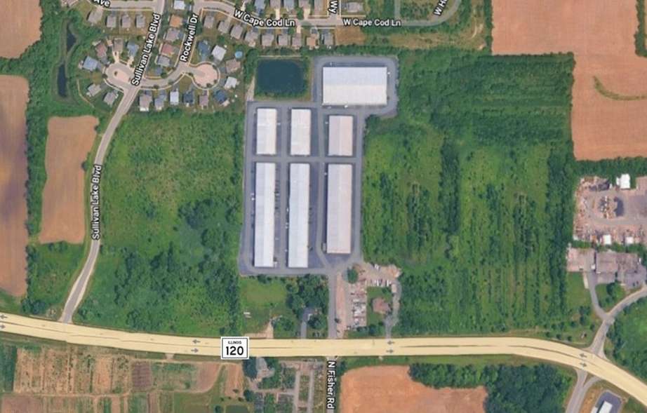 Aerial Aerial View of Lakes Region Commerce Park showing the tops of all 7 buildings and lush green surrounding