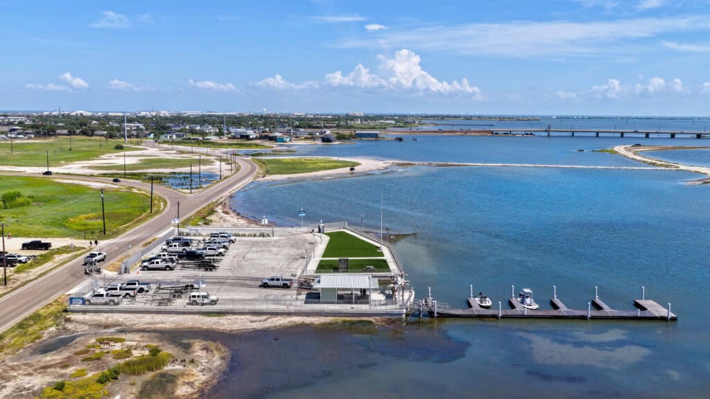 Boat Stop outdoor parking with Corpus Christi Bay in the background.